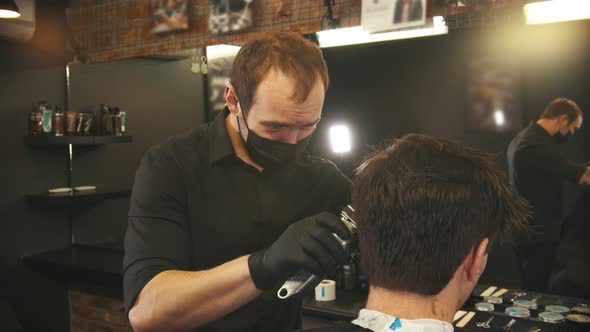 Barber Makes Hair Edging on the Sides of Client with a Hair Trimmer alt