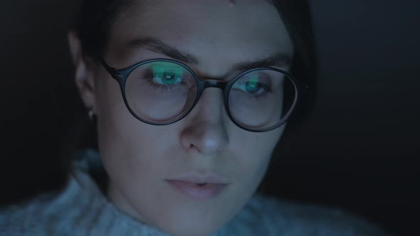 Portrait of a female working at the computer at night. alt