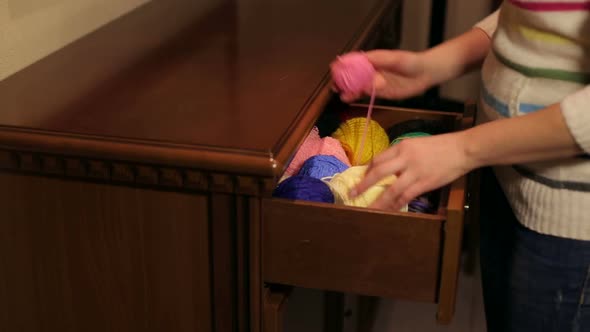 The Girl Pulls Out a Wooden Chest Skeins of Colored Thread alt