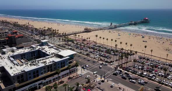 Huntington Beach symbol of Surf City, USA bird's eye view. Pacific highway with cars, pier and beach