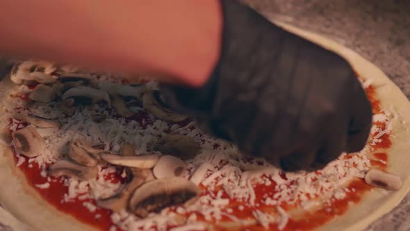Pizza maker adds mushrooms to pizza