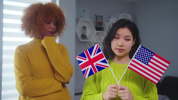 Work and Travel Program. Asian Woman Deciding Between United States and United Kingdom. African alt