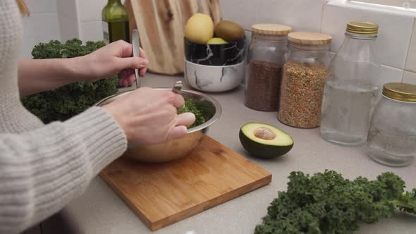 Woman's Hands Mixing Salad in A Salad Bowl