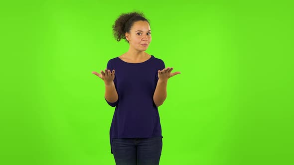 Curly Woman Is Upset, Waving Her Hands in Indignation. Green Screen alt