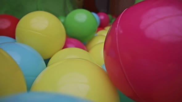 Macro Shot Through Group of Colorful Toy Balls alt