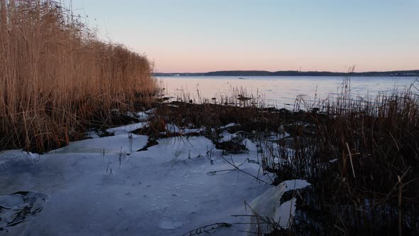 Drone Flight Over Frost And Ice In Inlet At Sunset alt