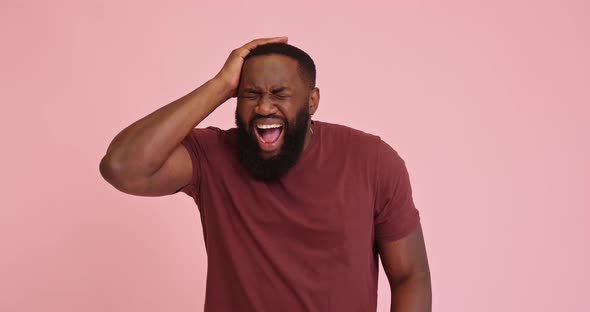 Young African American Man Scream Got Headache Isolated on Pink Background alt
