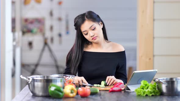 Tired Stylish Young Asian Woman Cooking Fresh Meal Having Headache Medium Shot alt