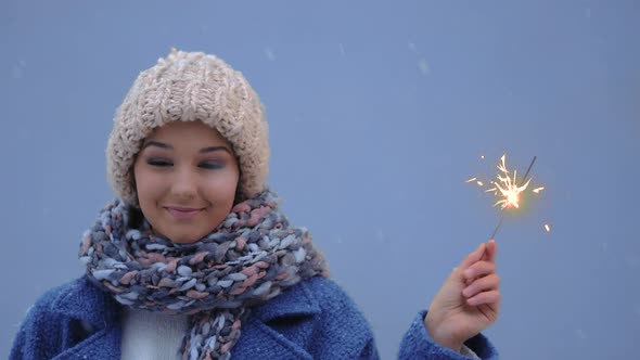 Winter Young Woman Portrait with Burning Firelight . alt