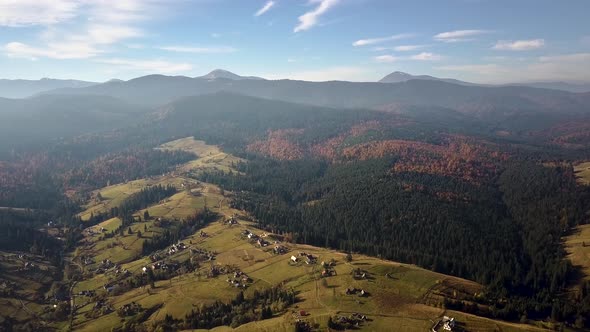 Aerial view of autumn mountain landscape with evergreen pine trees and yellow fall forest with alt