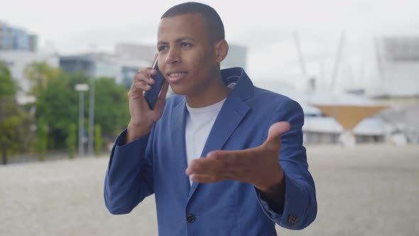 Emotional African American Man Talking on Smartphone alt