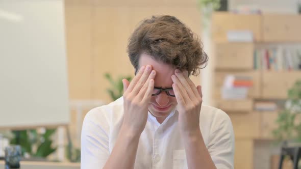 Portrait of Young Man Having Headache alt