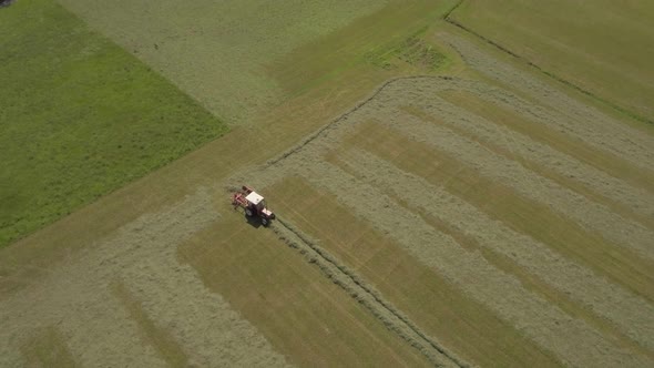Agriculture Tractor Harvest Field in Italy  Aerial Drone Follow Wide Shot