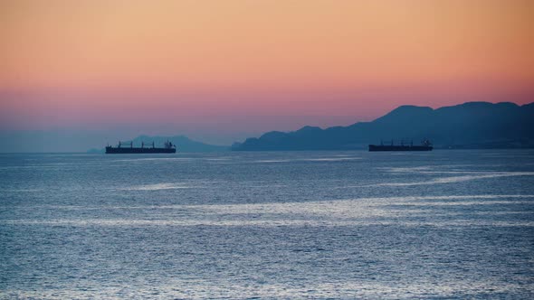 Sea At Evening With Cargo Ship On Horizon