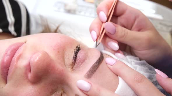 Permanent Makeup for Eyebrows of Woman with Thick Brows in Beauty Salon alt