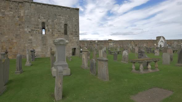 A graveyard under white clouds alt