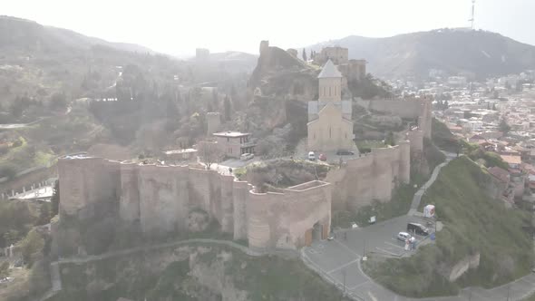 Capital Tbilisi old town buildings and Narikala fortress landmark on hill.Sightseeing in Georgia alt