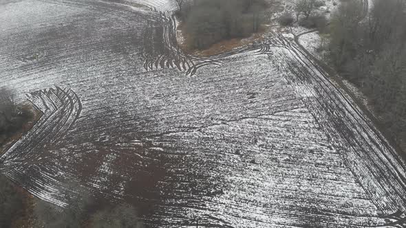 Stripe Pattern on Snow Covered Field Farm Concept Aerial alt