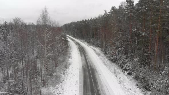 Winter Track Through the Forest and Trees Covered with Snow alt