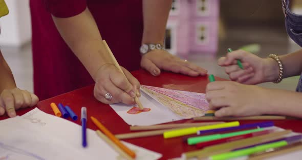 Creative Kids During an Art Class in a Daycare Center or Elementary School Classroom Drawing with alt