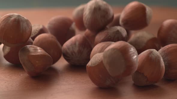 Hazelnuts falling onto wooden surface in super slow motion.  Shot on Phantom Flex 4K high speed came