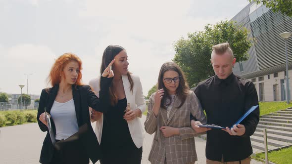 Businesswoman and Businessman Working in the Park. Businesspeople Communicate and Smile with Gadgets alt