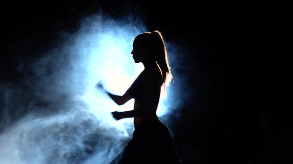 Karate Demonstration Performance Girl. Black. Silhouette. Backlight alt