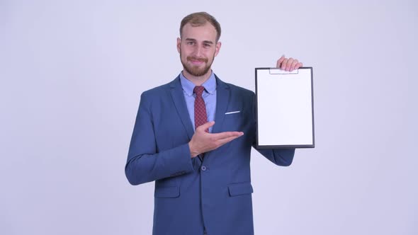 Happy Bearded Businessman Showing Clipboard and Giving Thumbs Up