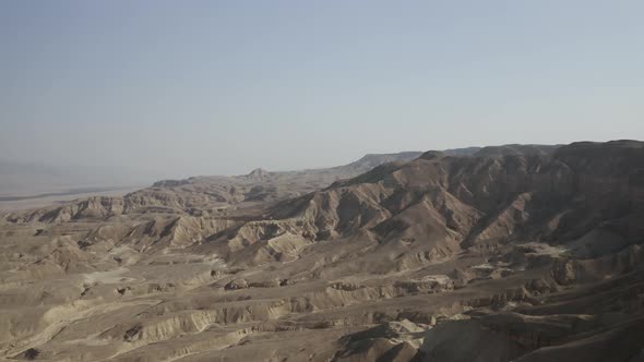 Aerial wide shot of the Dead-Sea desert mountains , clear sky day, drone shot alt