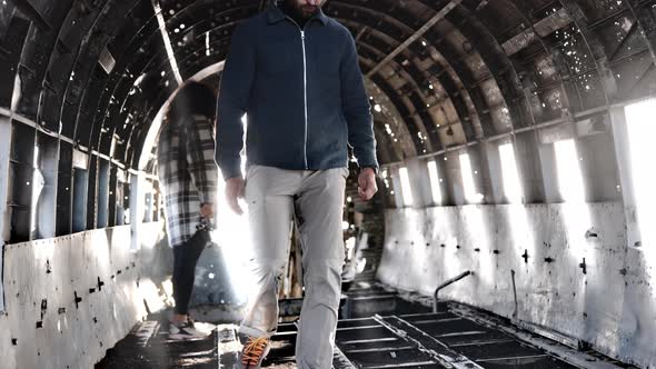 Amazing View of Two Adventurous Travelers Touring Inside the Solheimasandur alt