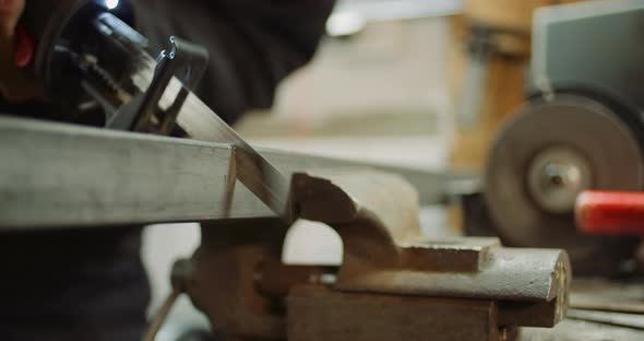 Industry Worker Metal Part with Electric Hacksaw alt