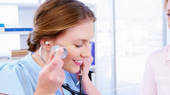 Female doctor examining a patient alt
