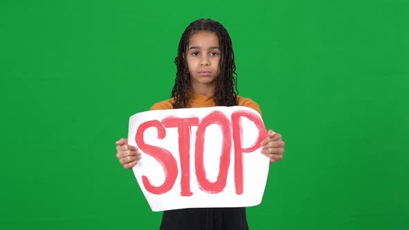 Frustrated Depressed African American Teenage Girl Showing Stop Message Banner Looking at Camera alt
