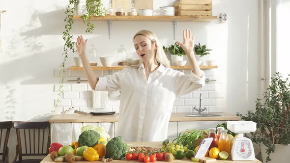 Caucasian Woman is Going to Cook in a Modern Bright Kitchen She is in a Good Mood and Dancing with