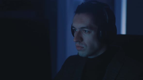Young Businessman Man in Headphones Working at Computer Late at Night alt