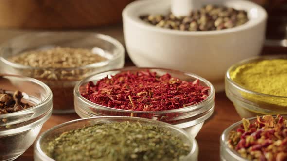 Various Spices in Glass Bowls Closeup alt