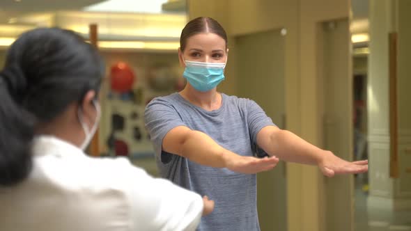 Woman in a Medical Mask Doing Exercises