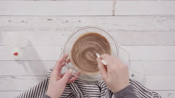 Flat lay. Preparing homemade chocolate ganache for chocolate raspberry cupcakes. alt