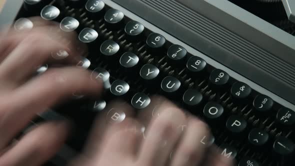 A man typing on a typewriter