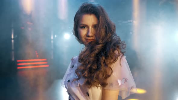 Sexy, Sensual and Seductive Woman with Long Hair Posing in Dress at the Night Club. Slow Motion Shot alt