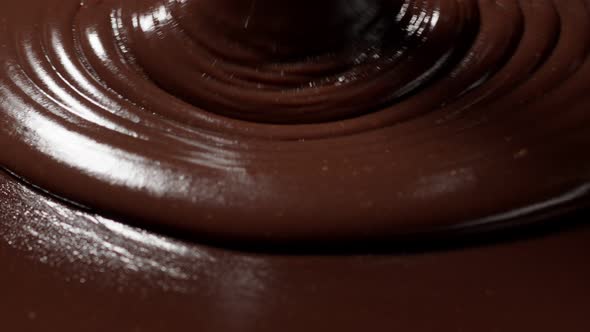 Pouring Melted Liquid Premium Dark or Milk Chocolate with Nuts Confectioner Prepares Dessert Icing alt