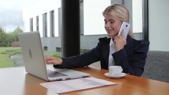 Woman Office Worker Holds Important Talks on the Phone alt