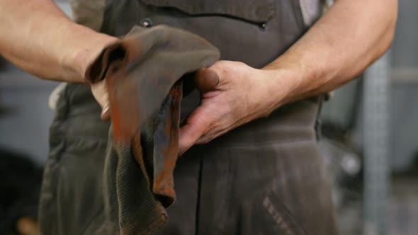 Crop Serviceman Wiping Hands with Napkin