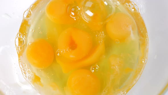 Organic Eggs Falling into Bowl