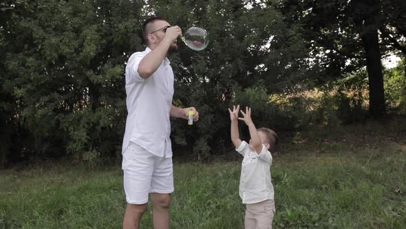 Father and His Son Making Soap Bubbles.