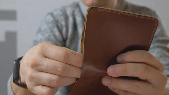 Hand Get Dollar Money Bills From Pocketsized and Foldable Wallet Made of Leather