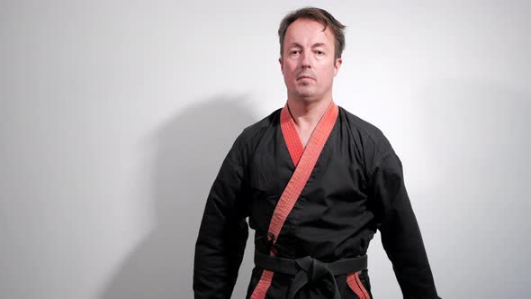 Black belt karate expert performs a martial arts kata. alt