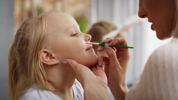 Close up video of face painting for little Easter bunny. Shot with RED helium camera in 8K alt