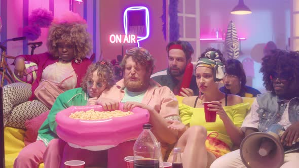 Friends Watching Horror Movie and Having Fun alt