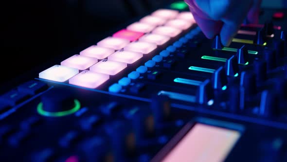Professional DJ Plays Beat Sampler with Color Drum Pads and Samples in Studio alt